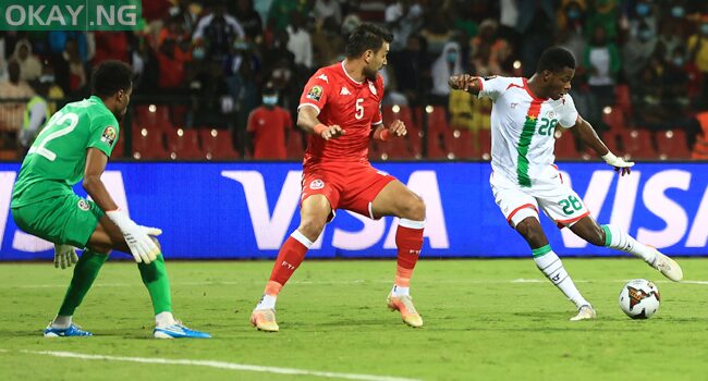 Burkina Faso’s forward Dango Ouattara (R) shoots to score his team’s first goal during the Africa Cup of Nations (CAN) 2021 quarter final football match between Burklina Faso and Tunisia at Stade Roumde Adjia in Garoua on January 29, 2022. Daniel BELOUMOU OLOMO / AFP