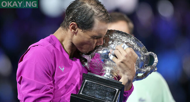 Spain’s Rafael Nadal kisses the Norman Brookes Challenge Cup trophy following his victory against Russia’s Daniil Medvedev in their men’s singles final match on day fourteen of the Australian Open tennis tournament in Melbourne on January 30, 2022. Martin KEEP / AFP