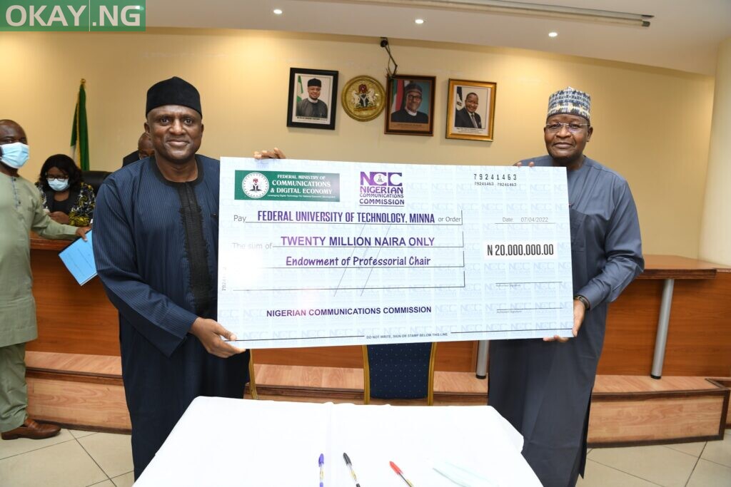 Prof Bala receiving a cheque from Prof Danbatta