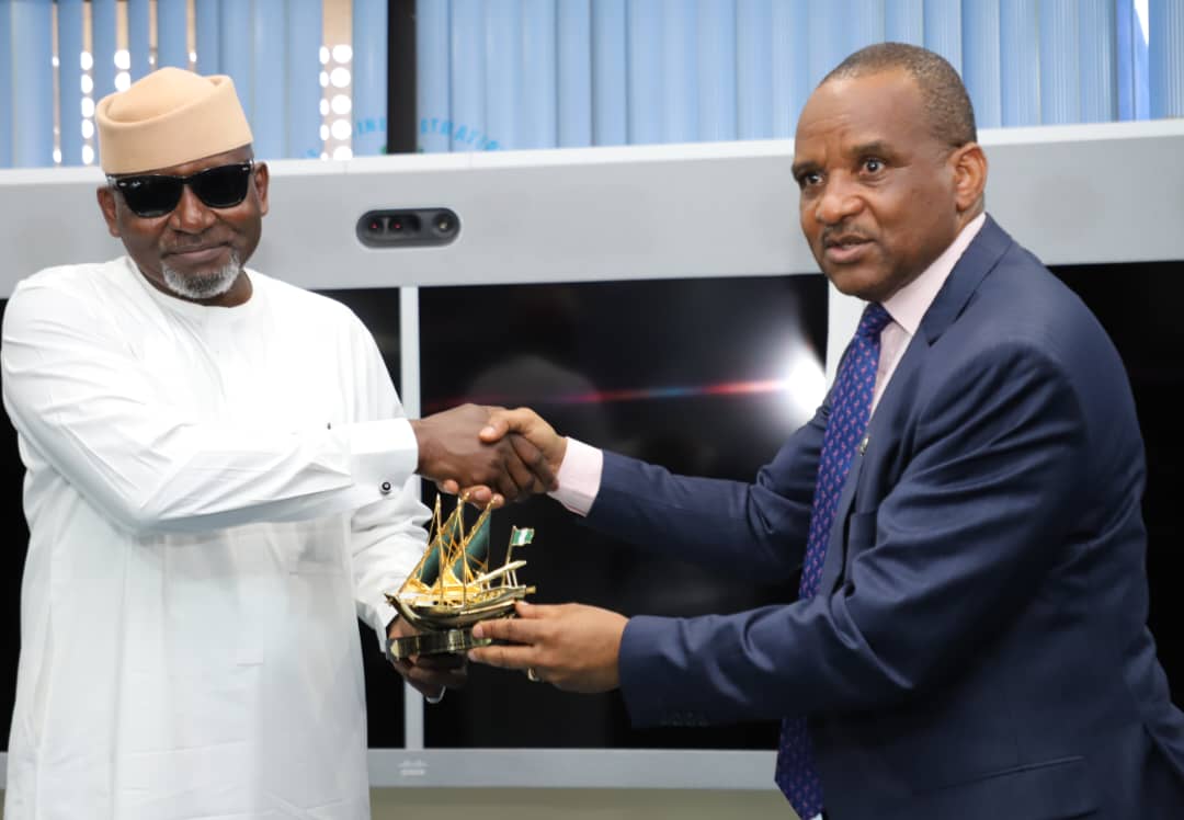 The Honourable Minister of Transportation, Engr. Mu'azu Jaji Sambo (left) receiving a souvenir from the Director General, Nigerian Maritime Administration and Safety Agency, NIMASA, Dr Bashir Jamoh during a visit by the Honourable Minister to the NIMASA headquarters in Lagos.