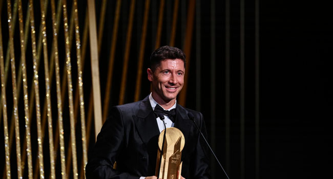 Bayern Munich’s Polish forward Robert Lewandowski receives for the second time the Gerd Muller Trophy for the best striker during the 2022 Ballon d’Or France Football award ceremony at the Theatre du Chatelet in Paris on October 17, 2022. (Photo by FRANCK FIFE / AFP)