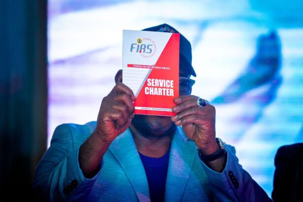 Mr. Muhammad Nami, Executive Chairman FIRS displays the FIRS Service Charter at the Charter launch by the Service on Tuesday in Abuja. [Tuesday October 4, 2022]