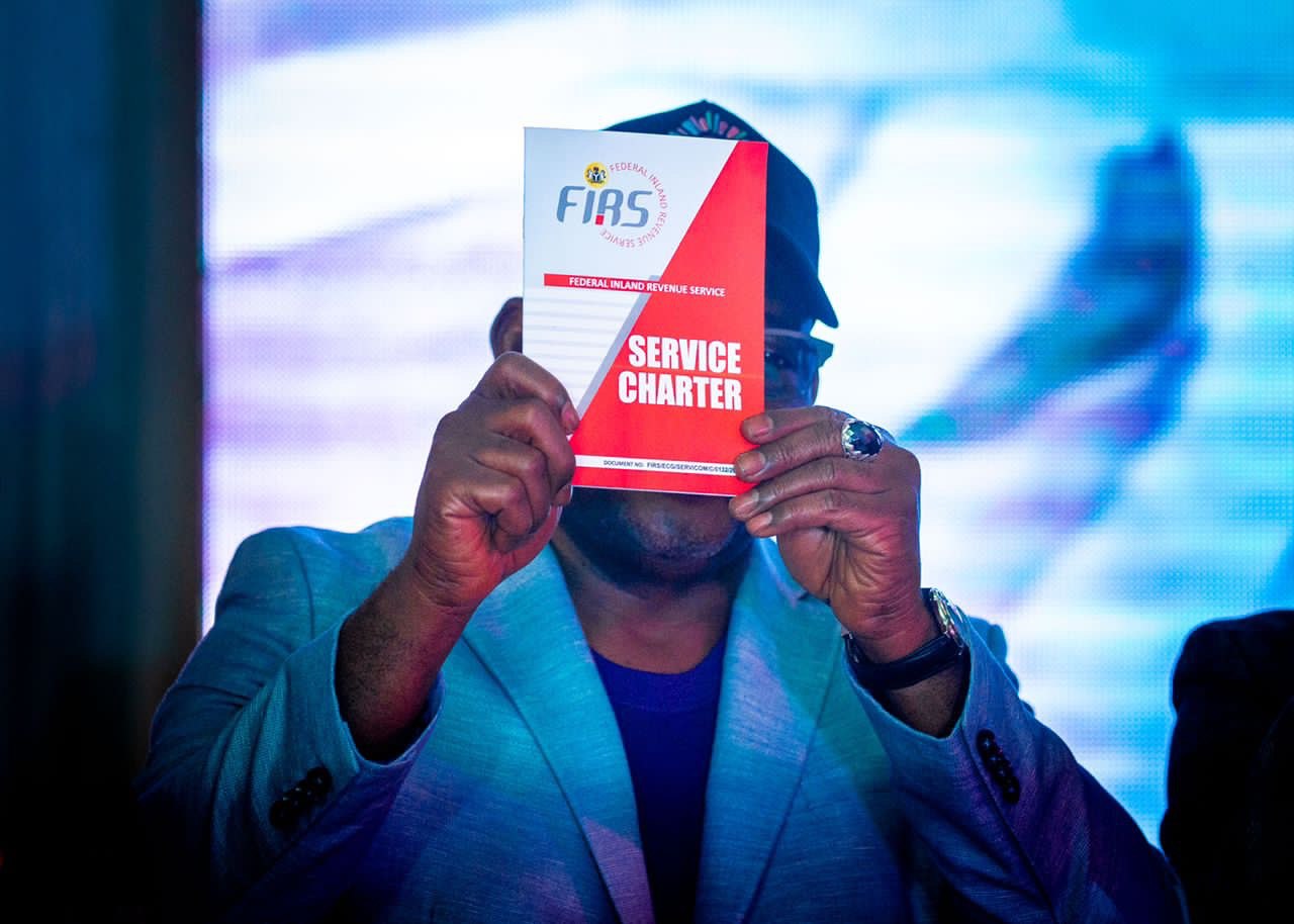Mr. Muhammad Nami, Executive Chairman FIRS displays the FIRS Service Charter at the Charter launch by the Service on Tuesday in Abuja. [Tuesday October 4, 2022]