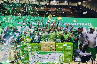 Boladale Odunlami, Commercial Manager, Nestlé Nigeria; Olabisi Joseph, President, Nigeria School Sports Federation (NSSF); and Ifeanyichukwu Orabuche, Category Manager, Beverages, Nestlé Nigeria, pose with the triumphant Father O’Connell Science College team after they clinched the male championship title at the 25th MILO Basketball Championship held at the Indoor Sports Hall, National Stadium, Lagos.
