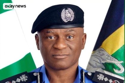 Official portrait of IGP Olutunji Rilwan Disu wearing a Nigeria Police Force uniform and beret, with national flags visible in the background.
