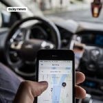 File Photo: Passenger operating the UBER app while on a ride