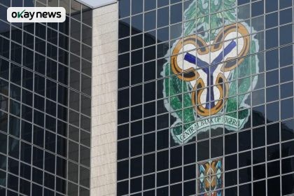 Central Bank of Nigeria headquarters building with the CBN coat of arms displayed on its glass facade in Abuja, Nigeria