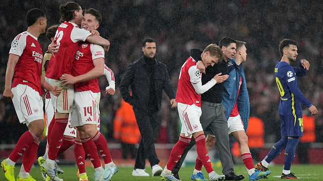 Arsenal's manager Mikel Arteta embraces Martin Odegaard and Leandro Trossard, right, at the the end of a Champions League semifinal, second leg, soccer match between Arsenal FC and Atletico Madrid. AP Photo