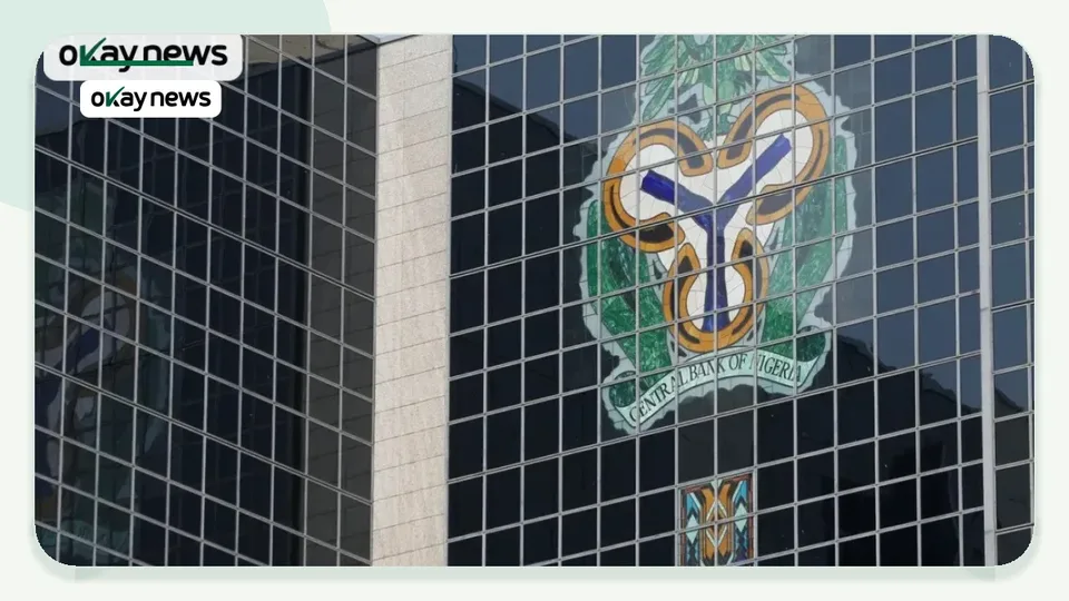 Central Bank of Nigeria headquarters building with the CBN coat of arms displayed on its glass facade in Abuja, Nigeria